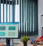 woman-with-face-mask-talking-phone-looking-desktop-analyzing-statistics-freelancer-working-workplace-chatting-with-remotely-team-speaking-smartphone-front-computer_482257-12886